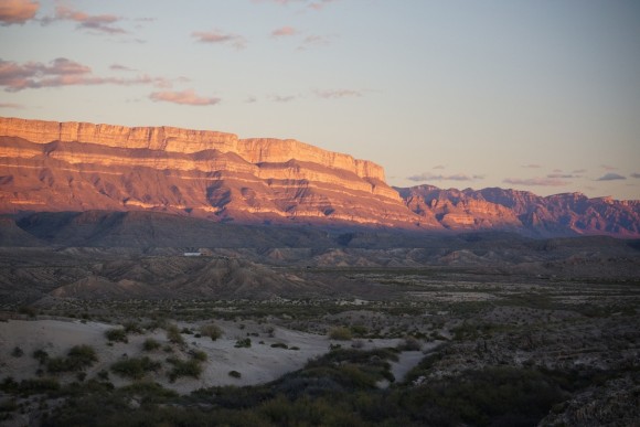 Sunset illuminating the Sierra Del Carmen mountains just behind the village of Boquillas, Mexico as seen from an overlook in Rio Grande Village, Big Bend National Park, Texas.