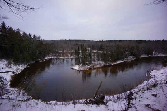 river bends of mansitee river in michigan during winter
